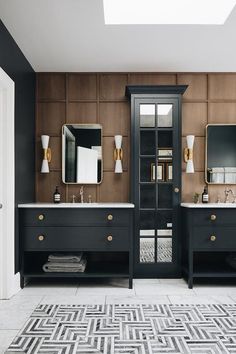 an image of a bathroom with black and gold decor on the walls, two sinks and mirrors