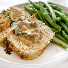 meatloaf with gravy and green beans on a white plate