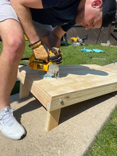 a man using a power tool on a piece of wood