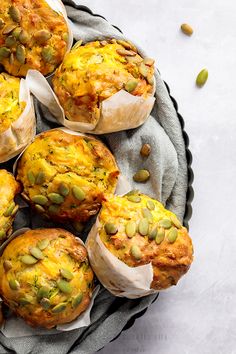 there are many muffins on the plate and one has pistachio seeds