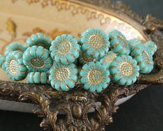 a bunch of blue flowers sitting on top of a metal stand in front of a mirror