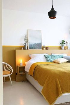 a bed room with a neatly made bed next to a night stand and two chairs