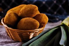 a basket filled with fried food sitting on top of a table