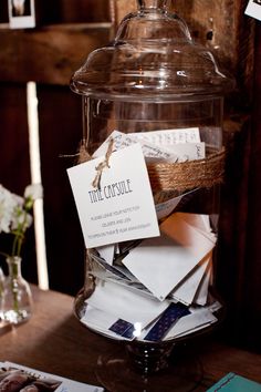 a glass jar filled with lots of papers