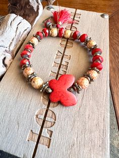 Red butterfly bracelet with beautiful czech beads, dyed howlite, silk tassel, leaf charm with bronze accents. Cute bracelet to add to your other stretchies.  *This listing is for the red butterfly. Other bracelets are in my shop unless sold.  Note: All my bracelet photos and videos, are in front of a large window to show natural lighting of the beads. If there are ANY issues with my artistry or product, I will honor my work Details:  Dyed howlite red butterfly stone Czech glass mustard with red Bohemian Wooden Beads Stretch Bracelet For Meditation, Red Bohemian Beaded Bracelets For Meditation, Red Hand-strung Bohemian Stretch Bracelet, Red Bohemian Hand-strung Stretch Bracelet, Butterfly Stretch, Hope Diamond, Cute Bracelet, Large Window, Red Butterfly