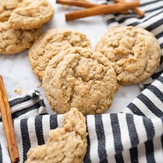 cookies and cinnamon sticks on a black and white towel