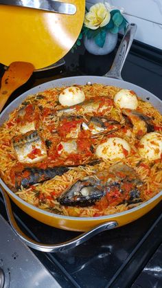 a pan filled with food sitting on top of a stove