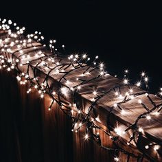 a fence covered in lots of white lights