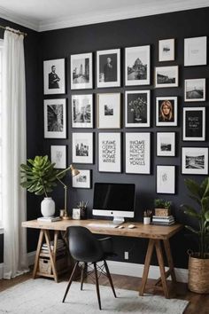 a home office with black walls and lots of pictures on the wall above the desk