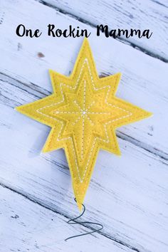 one rockin mama star ornament hanging on a white wooden background with text overlay that reads, one rockin mama