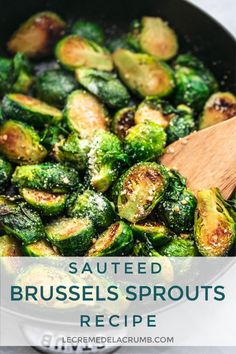 brussel sprouts are being cooked in a skillet with a wooden spoon