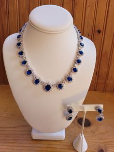 Created sapphire and diamond/zircon necklace and earring set.  5mm to 6mm sapphires and 1mm to 3mm diamond accents on necklace.  Chain is 18 inches non adjustable.  Earrings are 1.5 inches with a 1 inch drop.  4mm to 5mm sapphires and 1mm to 3mm diamond accents.  Set in stamped 925 silver. Round Cut Gemstone Jewelry For Evening, Fine Jewelry Sapphire Jewelry For Party, Evening Cubic Zirconia Jewelry With Prong Setting, Fine Jewelry Sapphire With Sparkling Stones, Fine Jewelry With Hand Set Sapphire, Fine Sapphire Jewelry For Party, Oval Cubic Zirconia Evening Jewelry, Elegant Hand Set Sapphire Jewelry, Dazzling Evening Jewelry With Prong Setting