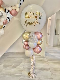 balloons and streamers are on the floor in front of a staircase with an inscription happy 30th birthday amanda