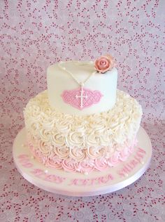 a white and pink cake sitting on top of a table