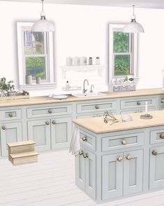 a large kitchen with blue cabinets and white walls, an island countertop and two windows