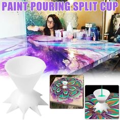 a woman is sitting at a table with paint pouring splat cup in front of her