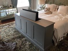 a bedroom with a bed, dresser and mirror cabinet in it's center area