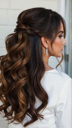 a woman with long, wavy hair in a ponytail