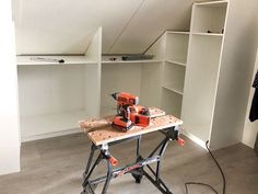 a workbench is sitting on a table in the middle of an unfinished room