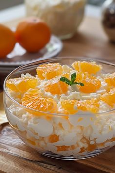 an orange dessert in a glass bowl on a wooden table