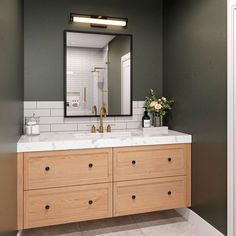 a bathroom vanity with two sinks and a large mirror above it, in front of a white tiled wall