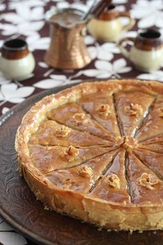 a pie sitting on top of a wooden plate