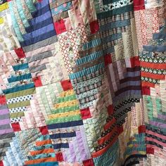 a colorful quilt is hanging on the wall