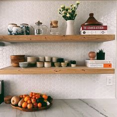 two wooden shelves filled with different types of dishes and fruit on top of each other