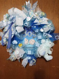 a blue wreath with white teddy bears on it