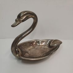 a metal bowl shaped like a swan