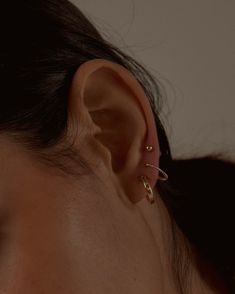 Elevate your everyday ear stack with these classic twisted hoops, perfect for both first and second piercings. Crafted in 14k gold fill and featuring a secure post with silicone backing, their dainty design makes them ideal for solo wear or layering with other earrings, offering effortless versatility to any look. …………………………………. Item Details: Sold as a pair Hoop diameter measures 12 mm Post length measures 9.5mm Closure type: post with silicone backs Tarnish-resistant, showerproof, safe for sensitive ears Lead-free and nickel-free Material: 14k Gold Filled Gold Hoop Stack, Piercings Minimal, Third Ear Piercing, Hoop Stack, Second Piercings, Second Piercing, Ear Stack, Pearl Collection, Ear Piercing