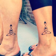 two people with matching tattoos on their feet