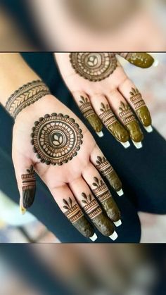 two hands with henna tattoos on them, one is green and the other is brown