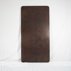 a wooden board sitting on top of a white sheet