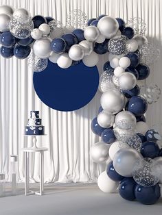 a balloon arch with blue and white balloons