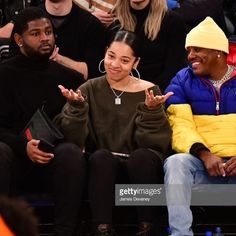 two people sitting next to each other at a basketball game