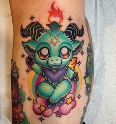 a small tattoo on the leg of a person with an animal and stars around it