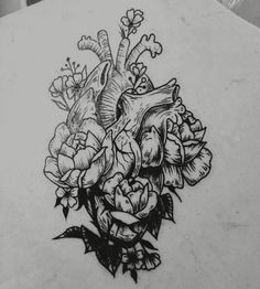 a heart and flowers tattoo on the back of a woman's shoulder, with an arrow in the center