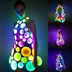 a woman in a dress made out of circles and neon lights is posing for the camera