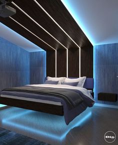 a large bed sitting in the middle of a room with blue lights on either side of it