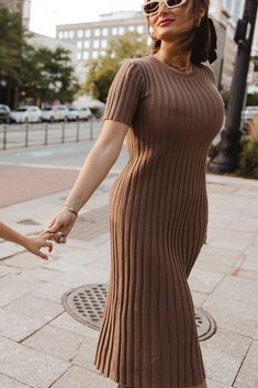 The perfect addition to your fall wardrobe is here - the Alexa Dress in Taupe! Made from a soft and comfortable taupe knit fabric, this modest women's dress features a round neckline and short fitted sleeves. The midi-length skirt and pull-over style make it both stylish and easy to wear. Plus, it's maternity friendly! Ribbed Knit Short Sleeve Dresses, Fall Midi Dress With Short Sleeves, Brown Ribbed Midi Sweater Dress, Ribbed Stretch Midi Dress With Short Sleeves, Stretch Ribbed Midi Dress With Short Sleeves, Brown Short Sleeve Midi Dress For Fall, Modest Short Sleeve Midi Dress For Fall, Modest Brown Midi Dress, Modest Short Sleeve Dresses For Fall