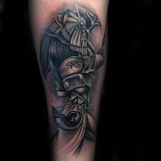 a man's arm with a black and grey tattoo on it