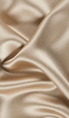 a close up view of a satin fabric with very soft folds and smooth lines on it