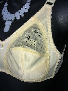 This is a lovely and very soft bra by a company called Winlove if I'm reading the tag correctly. It is wireless but does have options inside the cups for padding if you decide to put any in for an extra lift. Very pretty style, definitely made for beauty as well as comfort. Size 32B, lovely unworn condition. Full Coverage Cream Bra With Removable Pads, Cream Full Coverage Bra With Removable Pads, Classic Cream Bra With Padded Cups, Cream Full Coverage Bra With Medium Bust Support, Cream Full Coverage Bra With Medium Support, Art Deco Vanity, Bra Items, Peignoir Sets, Lingerie Bag