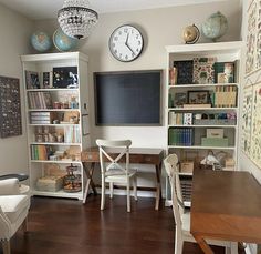 a living room filled with furniture and a large clock on the wall above it's bookshelf