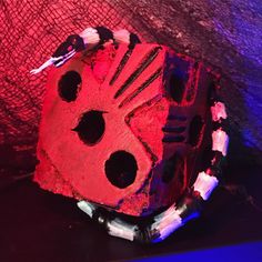 a red and black object with holes in it