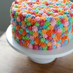 the cake is decorated with multicolored icing