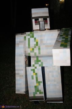 a homemade minecraft creeper costume made out of paper machs and cardboard boxes