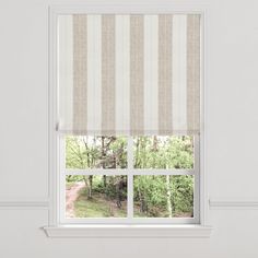 an open window with a striped roman blind in front of it and trees outside the window