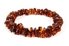 a bracelet made out of brown glass beads on a white background with clippings